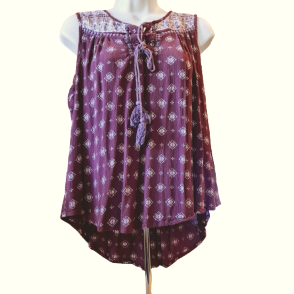 Sleeveless maroon top with tassels